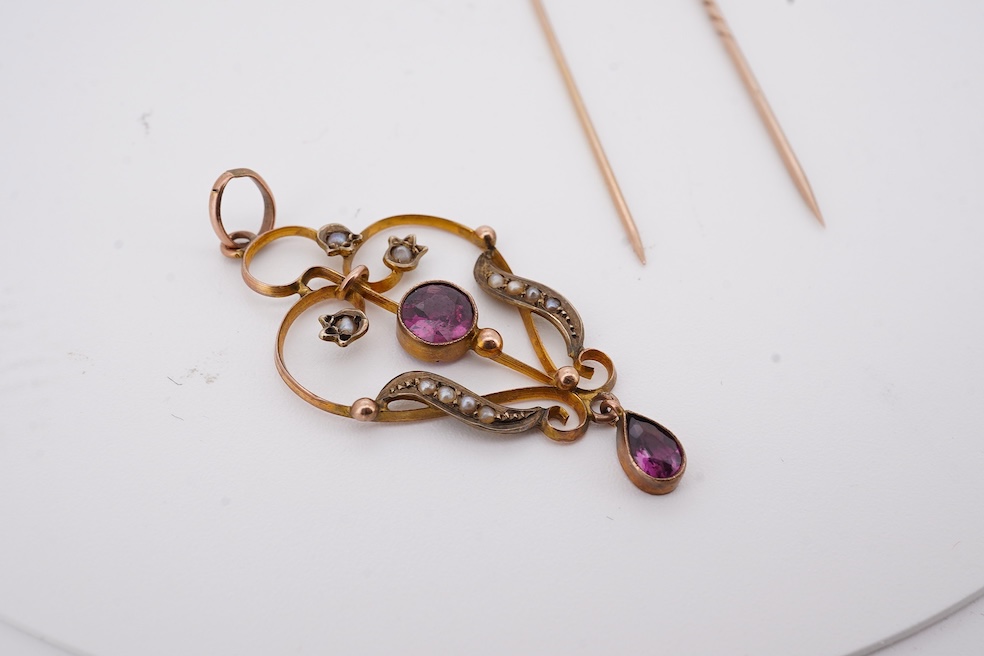 An Edwardian 15ct, diamond and seed pearl cluster set stick pin, 54mm, a similar yellow metal and cabochon garnet set stick pin and an Edwardian 9ct and gem set drop pendant. Condition - poor to fair